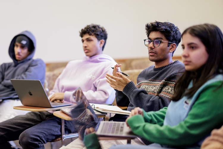 group of four students have discussion during class