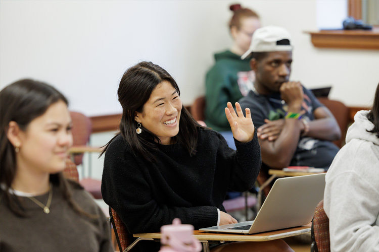 student raises hand in class